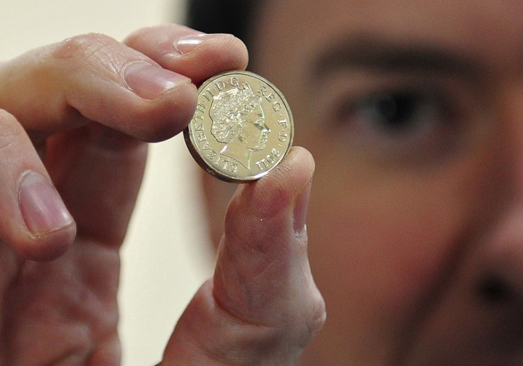 George Osborne holds coin