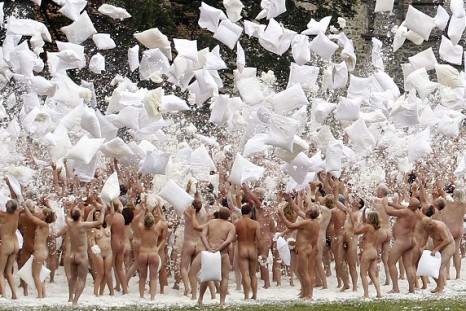 Naked volunteers pose for US artist Spencer Tunick as part of an early morning nude photo installation.