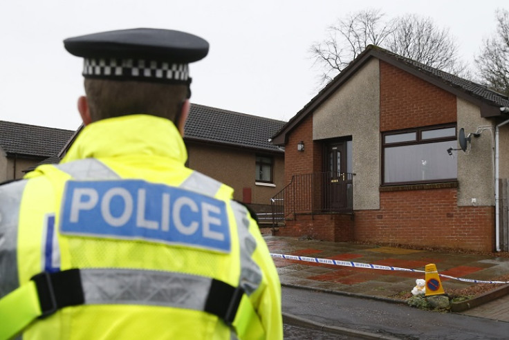 A police officer stands outside a house in Kirkcaldy, Scotland believed to belong to Mikaeel Kular's aunt.