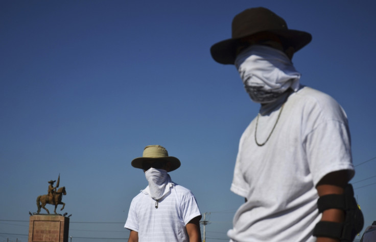 Vigilantes stand at a checkpoint in Mugica near Apatzingan January 14, 2014