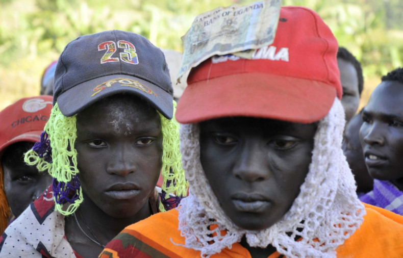 Teenage girls from Uganda's Sebei tribe queue before undergoing female genital mutilation in Uganda
