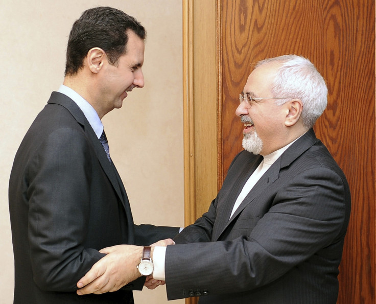 Syria's President Bashar al-Assad (L) welcomes Iran's Foreign Minister Mohammad Javad Zarif before a meeting in Damascus