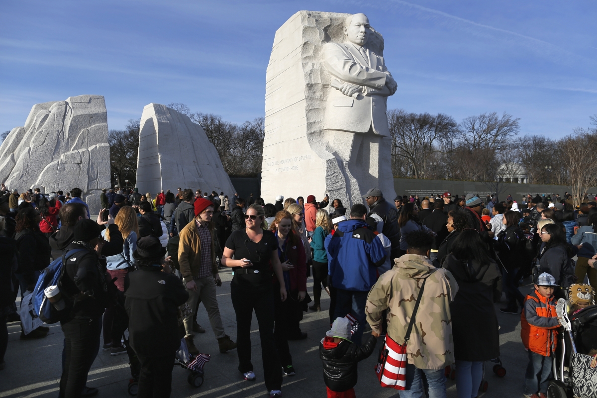 People visit the Martin Luther King Jr. Memorial on the U.S. national holiday in his honor, in Washington, January 20, 2014.