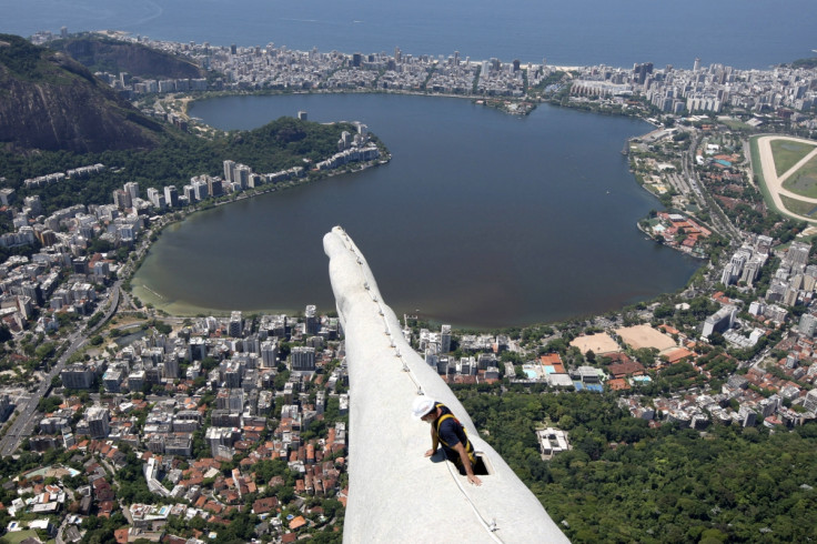 A worker begins work to fix lightning damage to the Christ the Redeemer statue in Rio de Janeiro, after an electrical storm