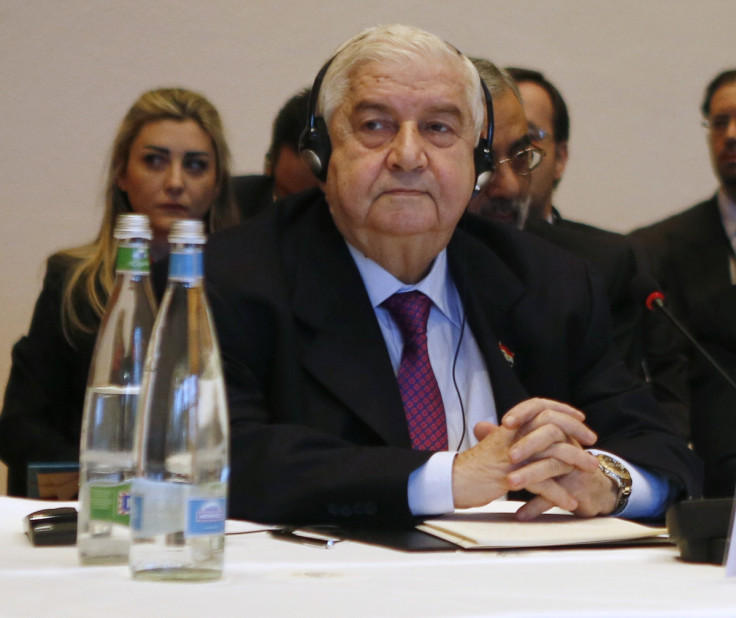 Syria's Foreign Minister Walid al-Moualem leads his delegation during a plenary session in Montreux