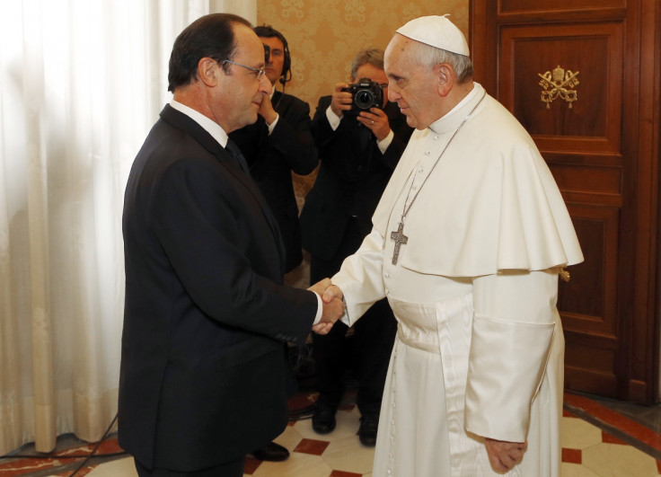 Pope Francis (R) shakes hands with French President Francois Hollande during a private audience at the Vatican