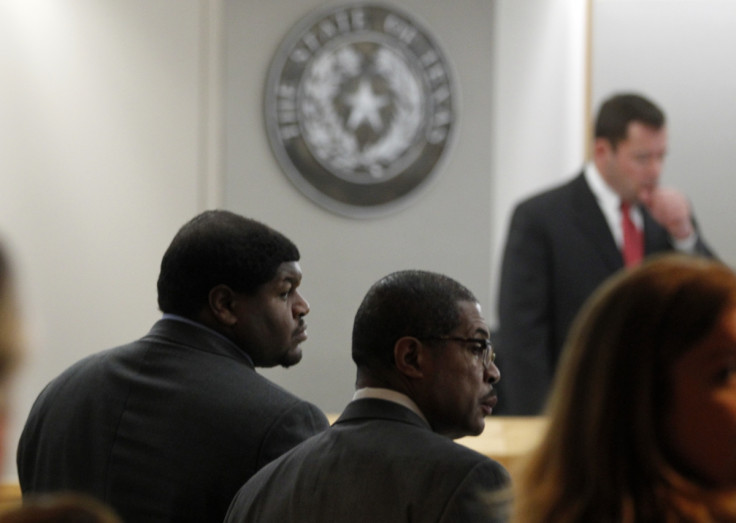 Former Dallas Cowboys player Josh Brent (L) and attorney Kevin Brooks stand in the court room as Judge Robert Burns (standing) presides in Dallas, Texas