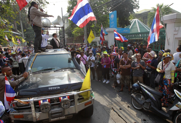 Anti-government protesters gather outside a polling station in central Bangkok
