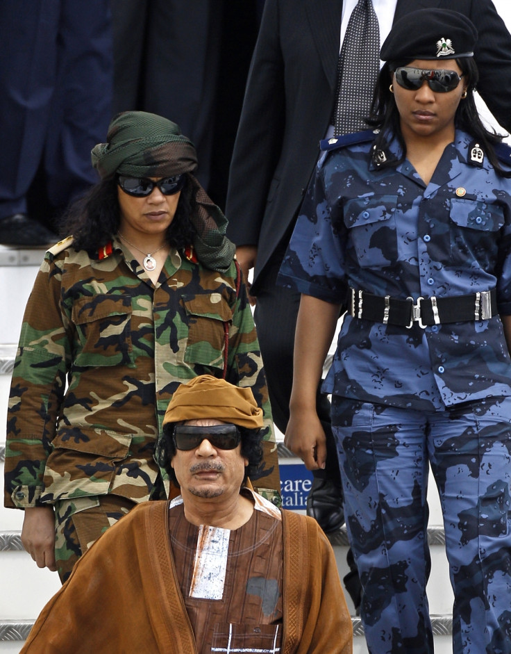 Muammar Gaddafi flanked by two of his female bodyguards on a visit to Rome in 2010.