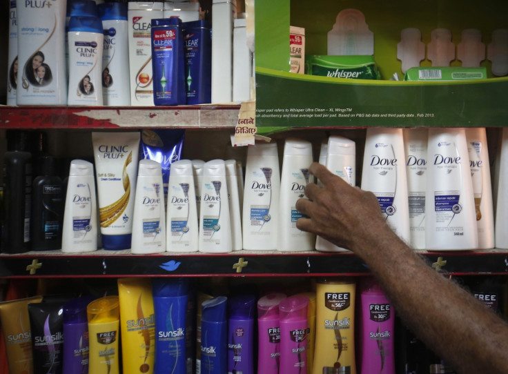 A salesman takes a bottle of Hindustan Unilever Limited (HUL) Dove shampoo from a shelf at a shop in Mumbai