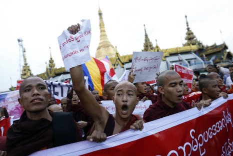Buddhist monks and other people protest against a visit to Myanmar by a high-level delegation from the Organization of Islamic Cooperation