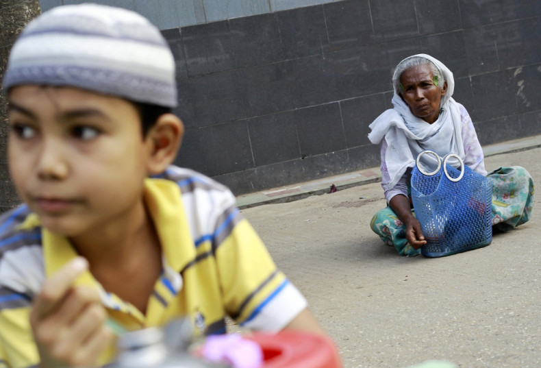 A Muslim woman sits near a mosque in Yangon