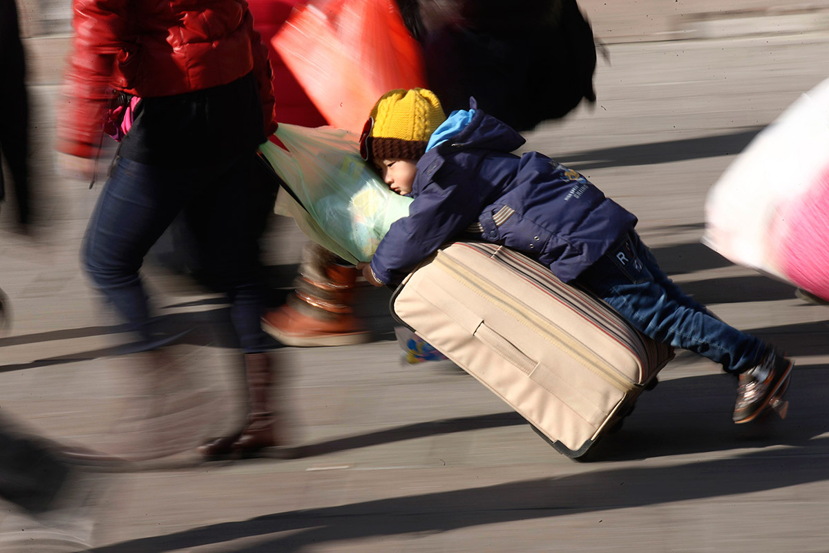 child on luggage