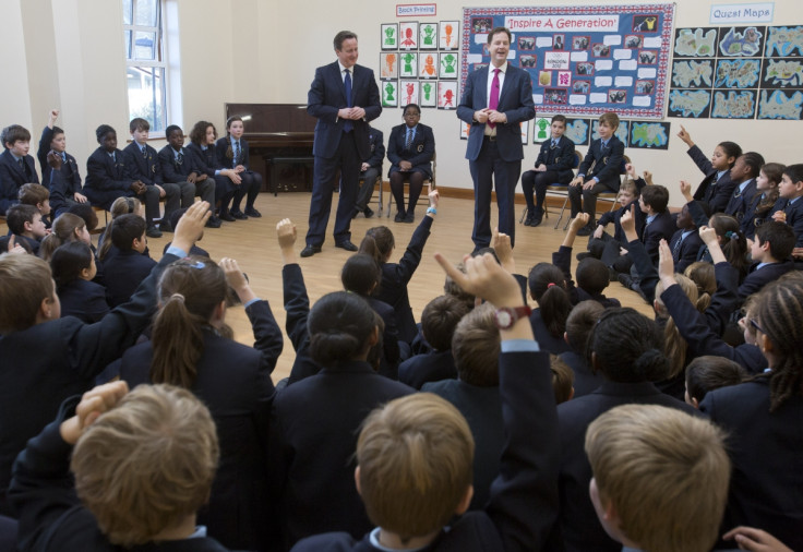 Britain's Prime Minister David Cameron and Deputy Prime Minister Nick Clegg (R) meet children at Corpus Christi Roman Catholic Primary School in Brixton in London