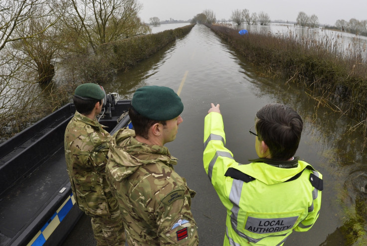 British army Royal Engineers are shown flooded areas by a local official near Muchelney village on the Somerset Levels