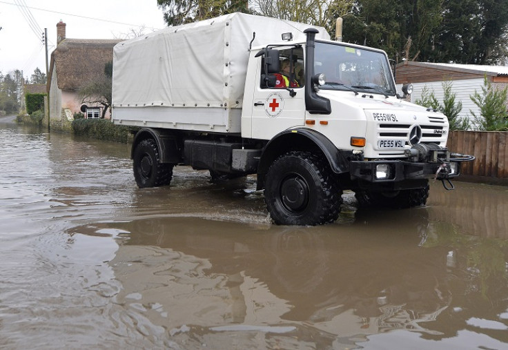 A Red Cross medical supplies vehicle drives through flooded parts of Somerset.