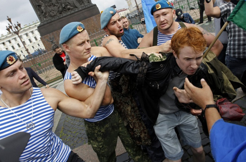 Former Russian paratroopers shove gay rights activist Kirill Kalugin during his one-man protest in St Petersburg.