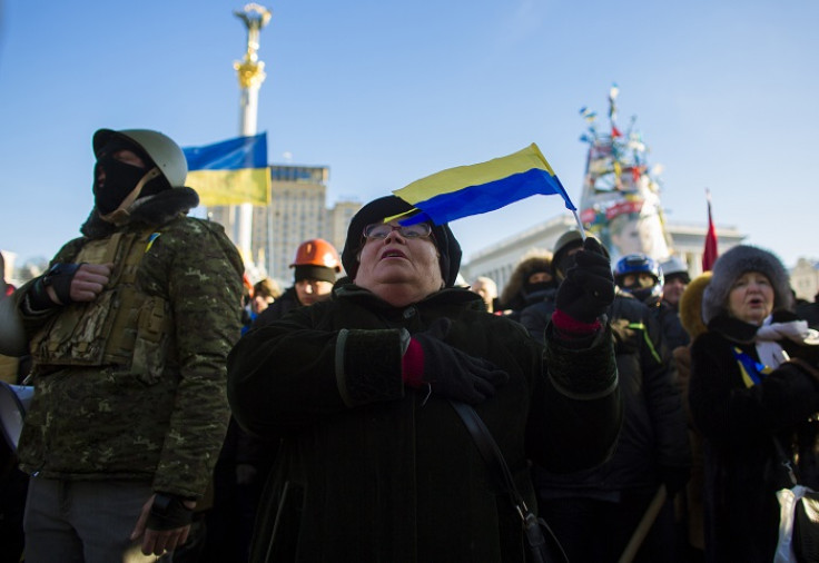 Anti-government protesters sing the Ukrainian national anthem during a rally at Independence Square in Kiev.