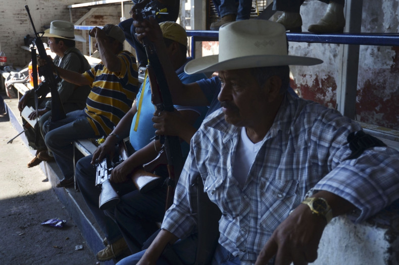 Vigilantes, or members of the community police, line up during a program to register their weapons and create a rural police in Paracuaro in Michoacan state