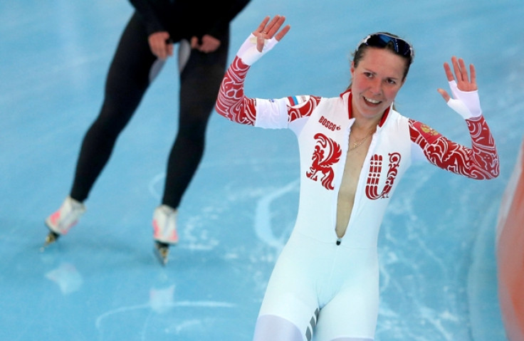 Olga Graf of Russia waves after her women's 3000 meters speed skating race