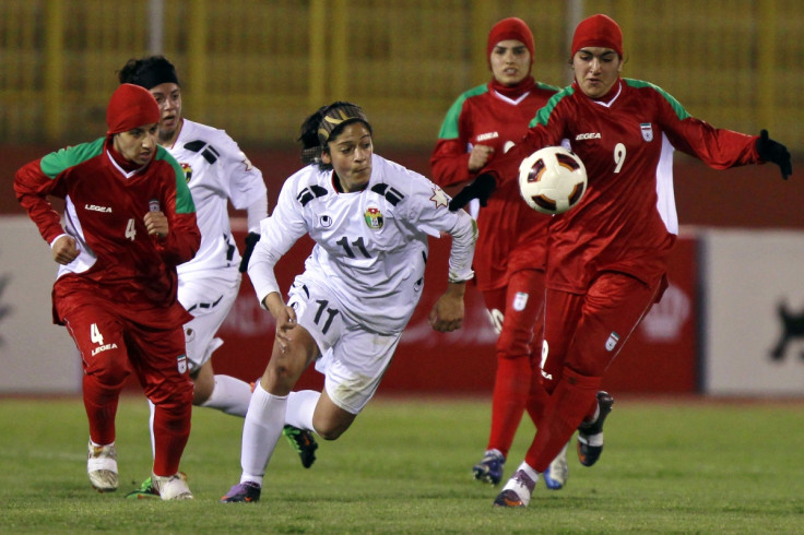 Women - or perhaps men, compete on the pitch for Iran against Jordan