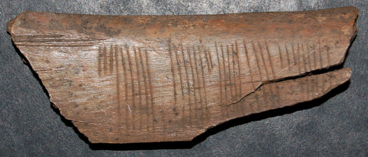 A Viking rune code on a 900-year-old piece of wood has been deciphered to say, 'Kiss Me'.