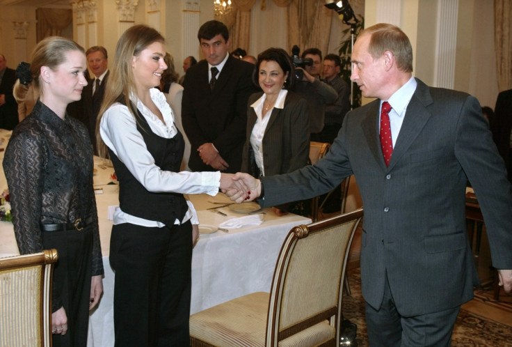 Russian President Vladimir Putin greets Alina Kabayeva at a meeting of Russian Olympians in 2004.