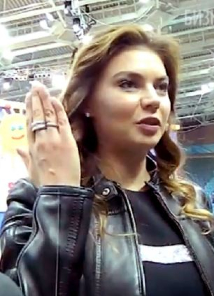 Kabayeva shows the ring to TV cameras.