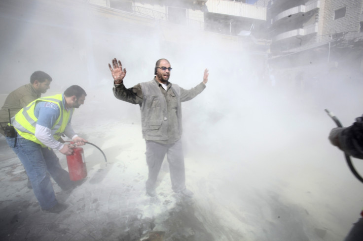 Civil defence members put out a fire at the site of an explosion in the southern suburbs of Beirut