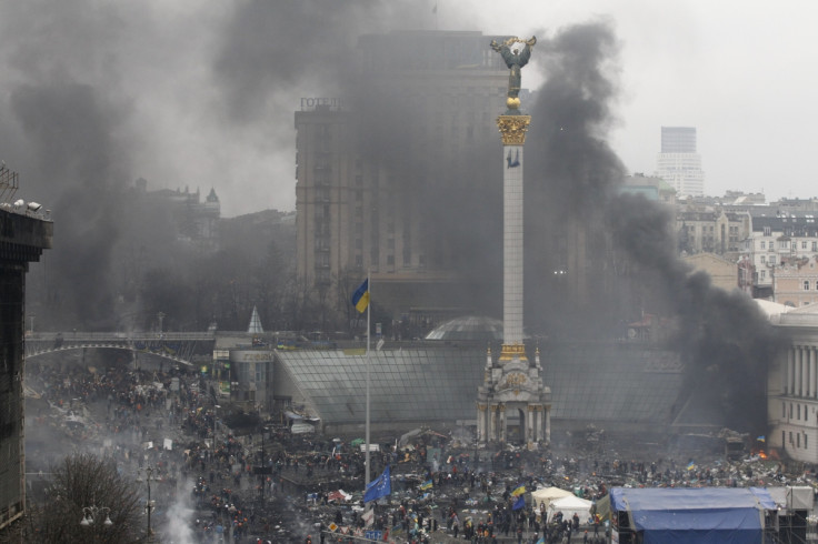 Smoke rises over Independence Square during clashes between anti-government protesters and riot police in Kiev