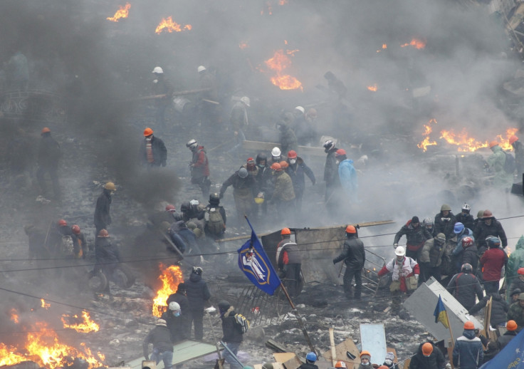 Anti-government protesters carry an injured man on a stretcher in Independence Square in Kiev