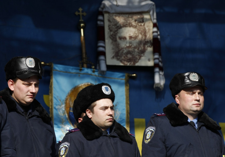 Police officers from Lviv who have arrived to join anti-government protesters appear on a stage in Independence Square in Kiev