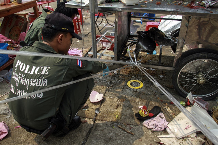 Thai police officers inspect the site of an explosion scene during an anti-government protest at Khao Saming district, Trat province February 23, 2014.