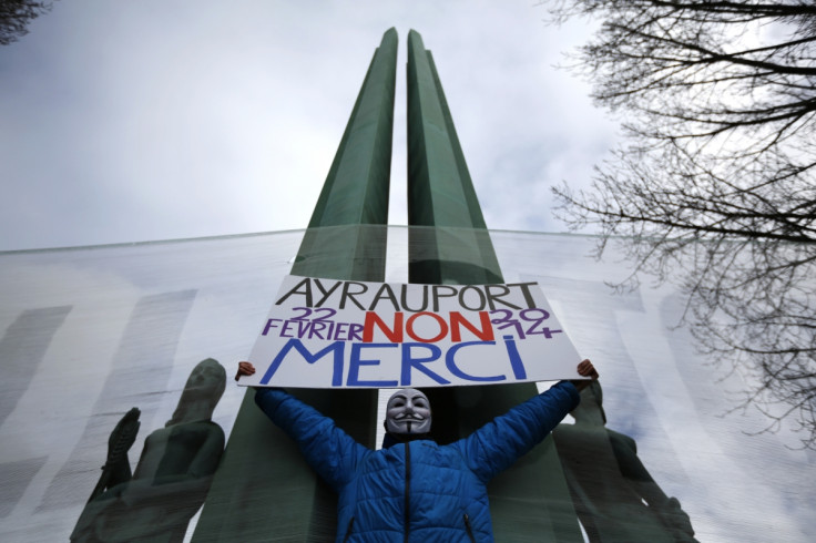 Farmers, ecologists and anarchists join together in a protest against the new French airport. The sign reads, "Airport, No Thanks".