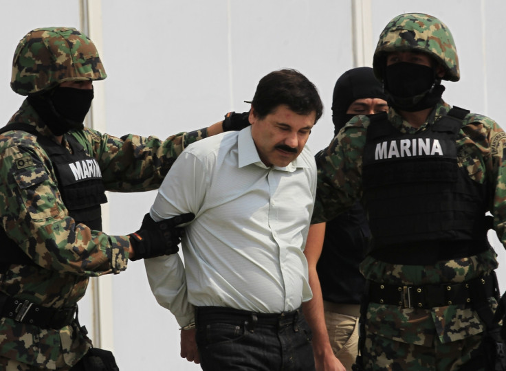 Joaquin "Shorty" Guzman, escorted by soldiers, is paraded before the media at the Navy's airstrip in Mexico City.