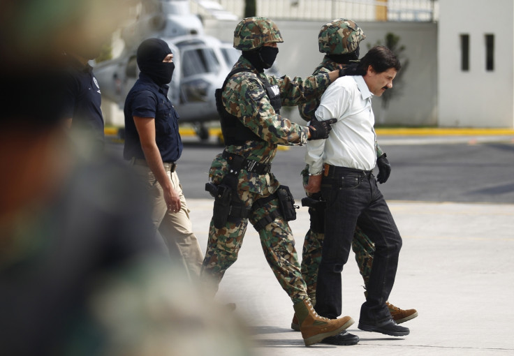 Guzman is escorted to a waiting heicopter by marines.