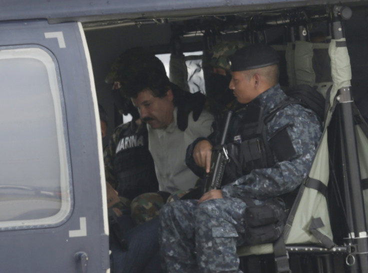 Guzman is seated on a federal police helicopter, ready to be transported to a high security detention facility.