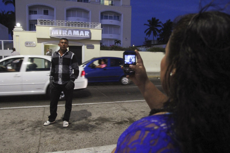 A man poses for a picture outside the apartment buildin in Mazatlan where Guzman was seized.