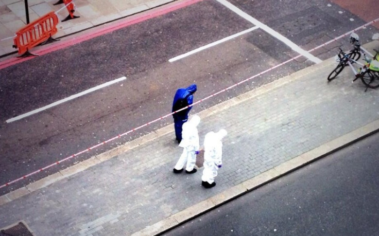 Police forensics officers at scene of fight in Bishopsgate, which cause delays around Liverpool Street station