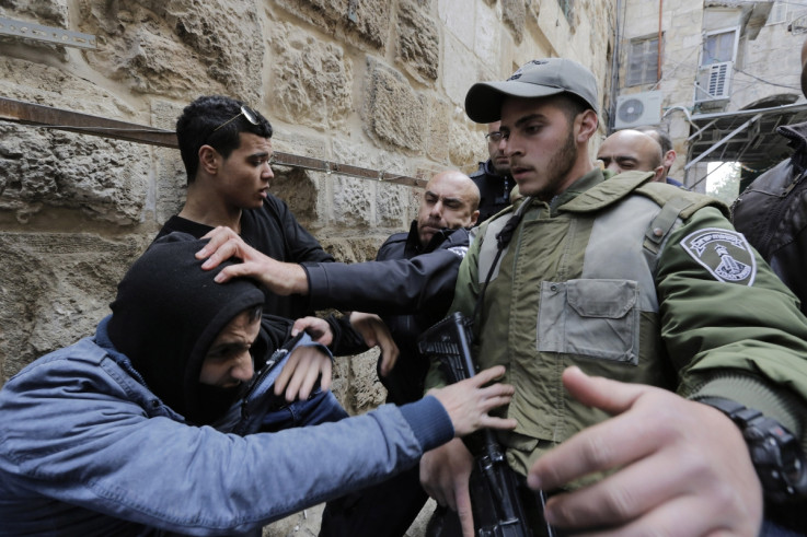 Israeli police and border police officers scuffle with a Palestinian who is trying to enter the compound known to Muslims as Noble Sanctuary and to Jews as Temple Mount in Jerusalem's Old City