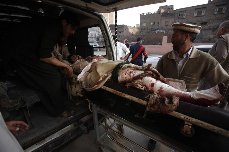 An injured man is carried out of an ambulance in Peshawar, northwest Pakistan.