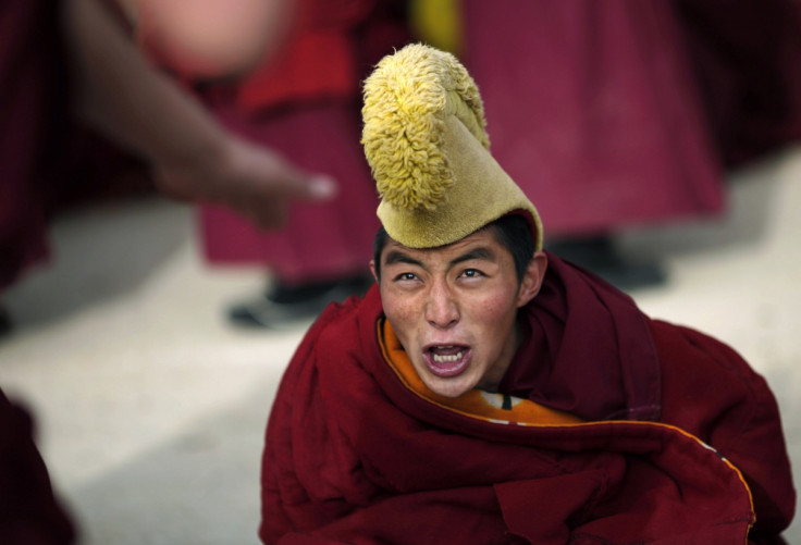 A monk's fury as he participates in a debate as part of Tibetan New Year celebrations at a temple in Langmusixiang, Sichuan Province