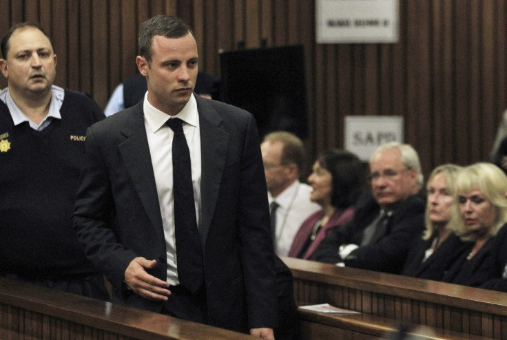 June Steenkamp watches Oscar Pistorius as Bladerunner takes a seat at his trial for killing Reeva Steenkamp