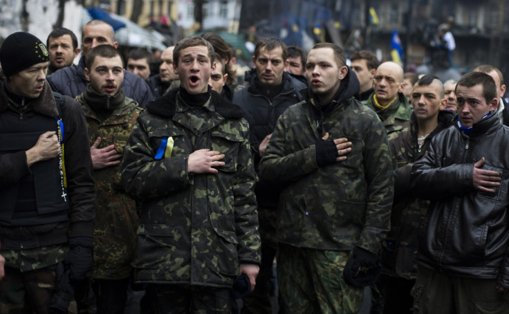 Members of a "Maidan" self-defense battalion sing the Ukrainian national anthem before remembering fallen comrades at the site of recent street battles near Independence Square in Kiev
