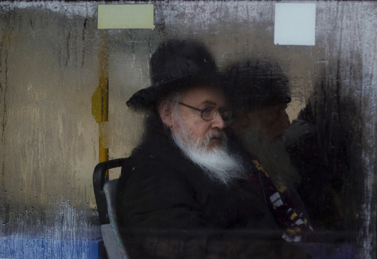 An Ultra-Orthodox Jewish man looks out of a fogged up bus window in Jerusalem