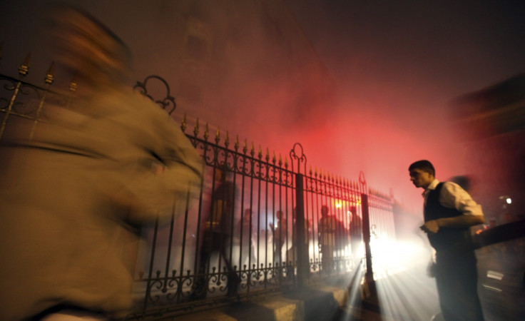 People flee from an explosion at an electricity plant at Al Hussien district in old Cairo May 22, 2012.