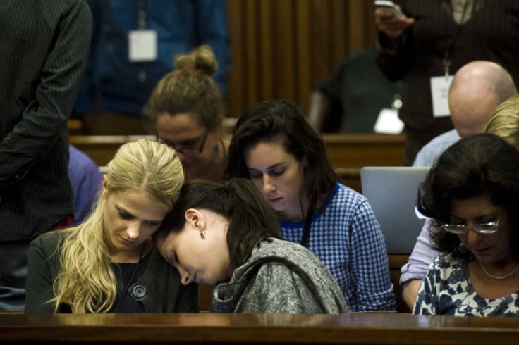 Aimee Pistorius leans on the shoulder of an unknown friend at the murder trial of her brother Oscar Pistorius for killing Reeva Steenkamp