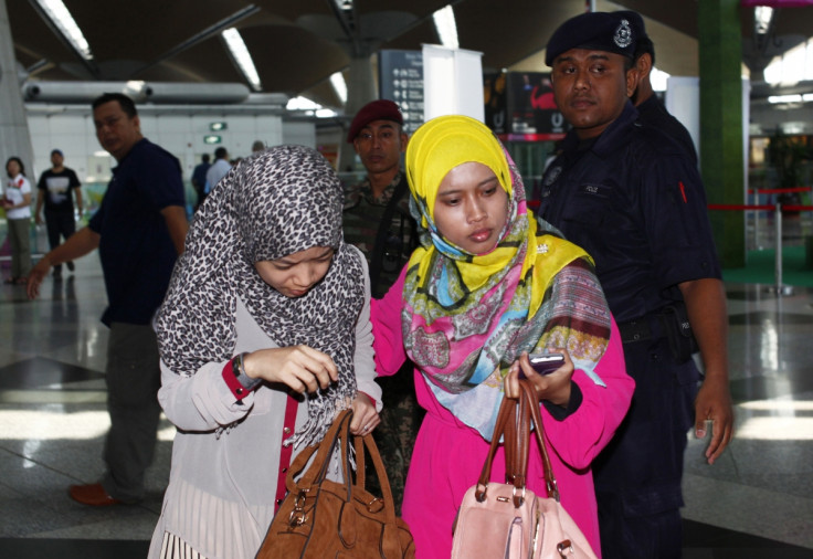 Family members of those onboard the missing Malaysia Airlines flight walk into the waiting area at Kuala Lumpur International Airport in Sepang March 8, 2014.