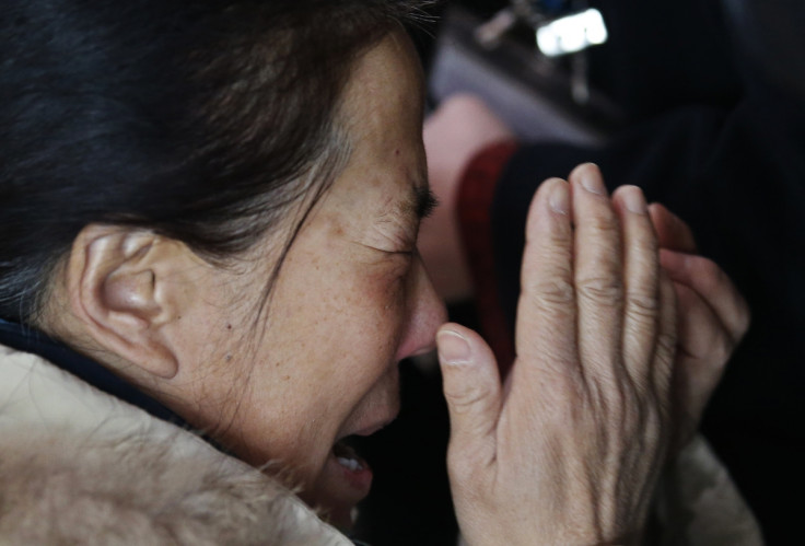 A relative of a passenger onboard Malaysia Airlines flight MH370 cries at the Beijing Capital International Airport in Beijing March 8, 2014. A relative of a passenger onboard Malaysia Airlines flight MH370 cries at the Beijing Capital International Airport in Beijing March 8, 2014.