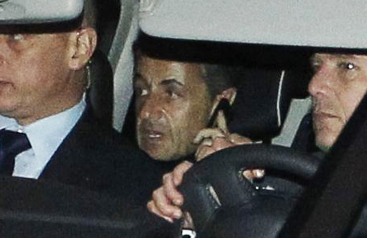 Former French president Nicolas Sarkozy speaks on the phone after leaving a courthouse in Bordeaux in November, 2012.